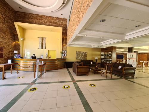 a lobby with couches and chairs in a building at Hotel Agua del Desierto in Calama