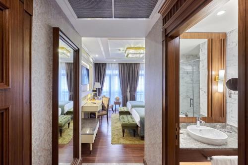 a hotel room with a bathroom and a bedroom at Aspera Hotel Golden Horn in Istanbul