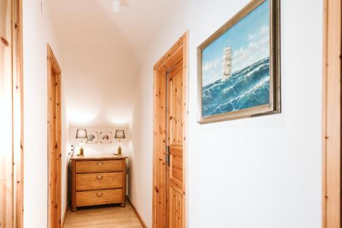 a hallway with a door and a picture of a lighthouse at mirnockAHOI - familienfreundliches Ferienhaus für 4 Erwachsene, maritimes Bergerlebnis, Panoramablick von Terrasse und Balkon, Carinthia, Millstättersee in Ferndorf
