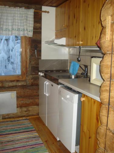 a kitchen with a sink and a counter top at Hakamajat Cottages in Syöte
