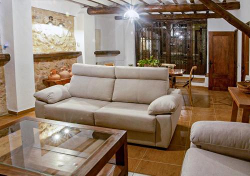 a living room with a couch and a table at Casa rural El Molino de Bogarra in Bogarra