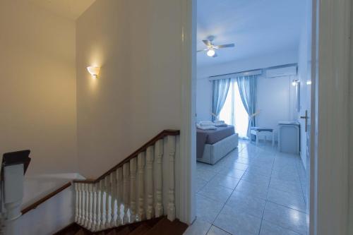 a hallway with a staircase and a living room at Fedra Mare in Agios Stefanos