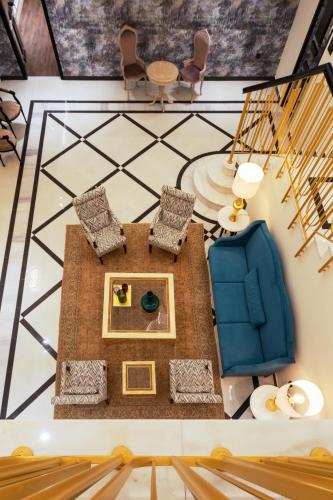 a view of a living room with chairs and a table at Kyniska Palace Conference & Spa in Mystras