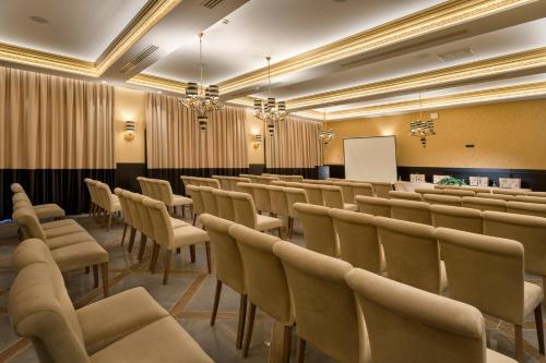a conference room with chairs and a whiteboard at Kyniska Palace Conference & Spa in Mystras