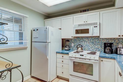 a kitchen with white appliances and a white refrigerator at Beckenham in Hilton Head Island