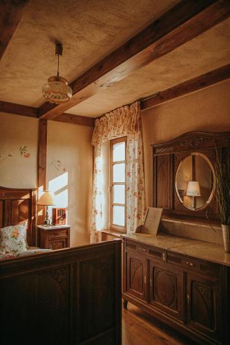 a room with a bed and a mirror and a window at Gościniec na Półwyspie in Międzyrzecz