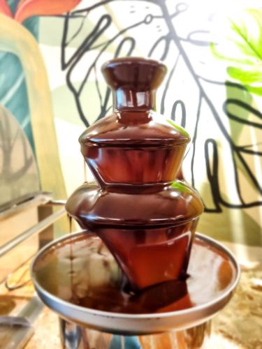 a chocolate bottle on a plate on a table at Mirasol Copacabana Hotel in Rio de Janeiro