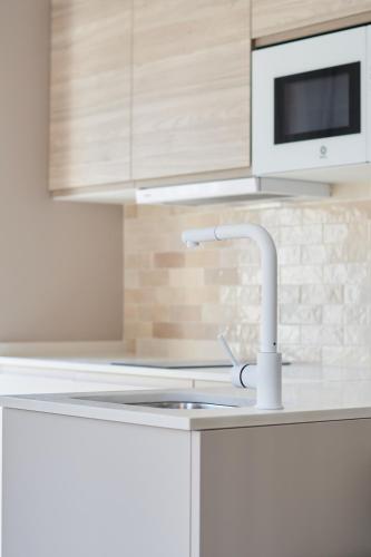 a kitchen with a sink and a faucet at Slow Home Apartments in Valencia