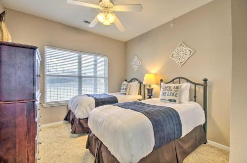 a bedroom with two beds and a ceiling fan at Top-Floor Lands End Corner Unit with Resort Perks! in Osage Beach