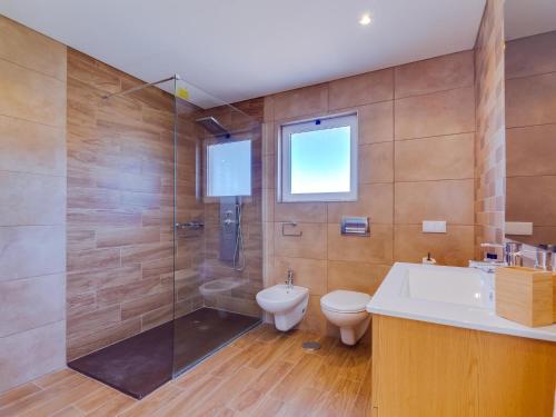 a bathroom with a shower and a toilet and a sink at Vilamoura ZEN Garden, private 3bdr vila with pool in Vilamoura