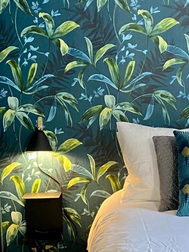 a bedroom with a blue and yellow floral wallpaper at Paradise Penthouse Suite Amazing View in Rome