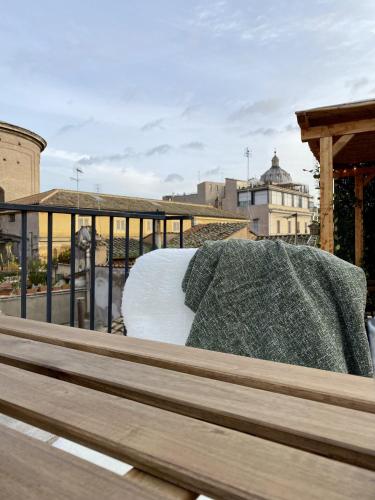 a bench with a blanket on top of a building at Paradise Penthouse Suite Amazing View in Rome
