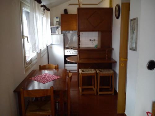 a small kitchen with a table and a dining room at Apartment Old Town in Pula
