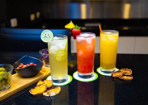 a group of three drinks sitting on a table at Palmetto Hotel Business San Borja in Lima