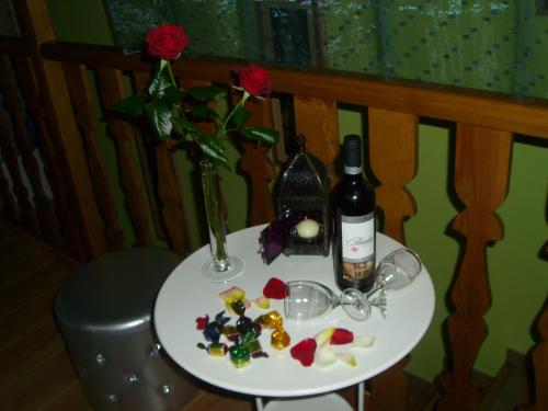 a table with a bottle of wine and flowers on it at La Fuente in Umbrías