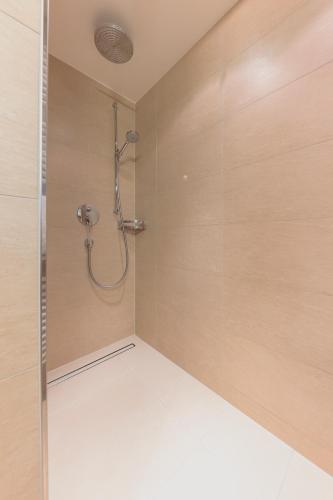 a shower with a glass door in a bathroom at m3Hotel in Sankt Anton am Arlberg