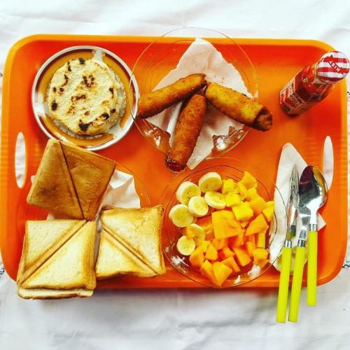 a tray of food with cheese crackers and other foods at Chao Beach Villa in Ahangama