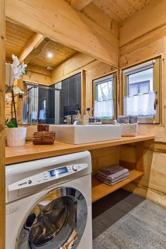 a kitchen with a washing machine in a room at Domy Z Bali in Zakopane