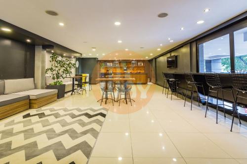 a lobby with chairs and a table in a building at Century Park by My Way in Porto Alegre