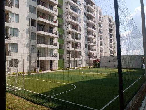 a soccer field in front of a apartment building at Hermoso apartamento Ricaurte in Ricaurte