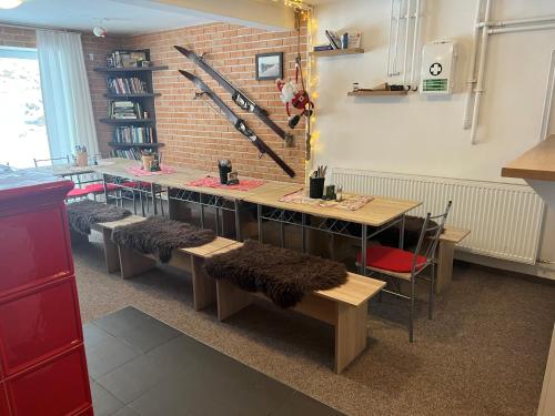 a room with a table and benches with furry seats at Severka in Háj