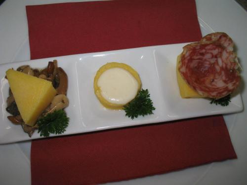a plate of food on a red table at Albergo Miramonti Dependance in Asiago