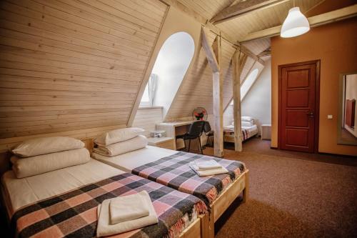 a bedroom with a large bed in a room at Guest House "Arkhistratyg" in Lviv