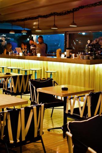 a restaurant with tables and chairs and a bar at Paliria Hotel in Chalkida
