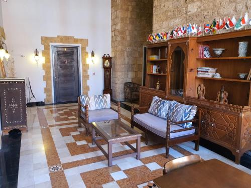 a living room with two chairs and a table at Azur Suites Hotel & Apartments in El Mîna
