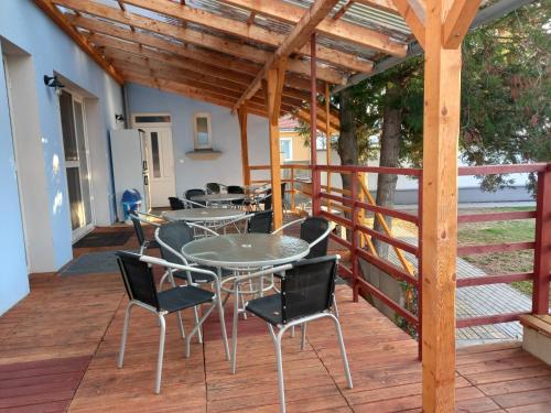 a group of tables and chairs on a deck at Alegria Natur Apartments in Mikulov