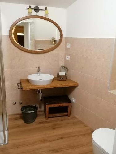a bathroom with a sink and a mirror at Locanda Dell'Oleificio in Mezzane di Sotto