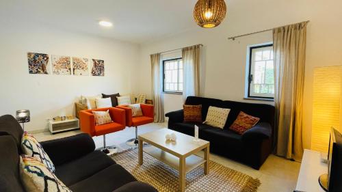 a living room with a couch and a table at Bicos 101 by Check-in Portugal in Albufeira