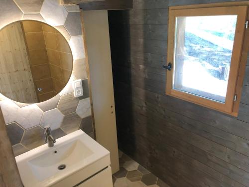 a bathroom with a sink and a mirror at La maison de l'O in Saint-Laurent-des-Hommes