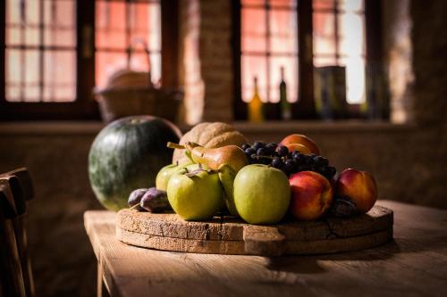a pile of fruit sitting on a wooden table at Locanda Dell'Oleificio in Mezzane di Sotto