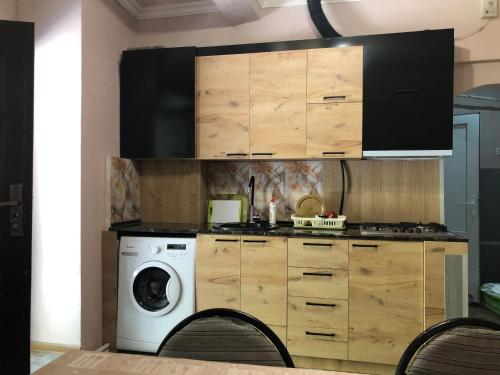 a kitchen with a washing machine and a washer at Metax House Yerevan in Yerevan