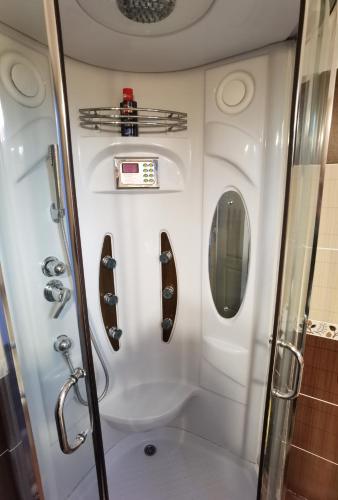 a small bathroom with a shower and a toilet at Garden Villa in Braşov
