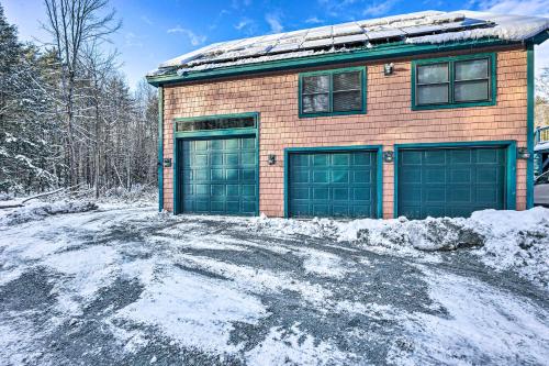 a brick house with two garage doors in the snow at Dog Heaven Clarendon Studio about 15 Mi to Skiing in Rutland