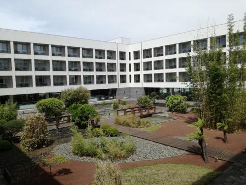 an external view of a building with a courtyard at Azoris Royal Garden – Leisure & Conference Hotel in Ponta Delgada