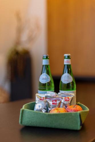 two bottles of beer in a tray with snacks at m3Hotel in Sankt Anton am Arlberg