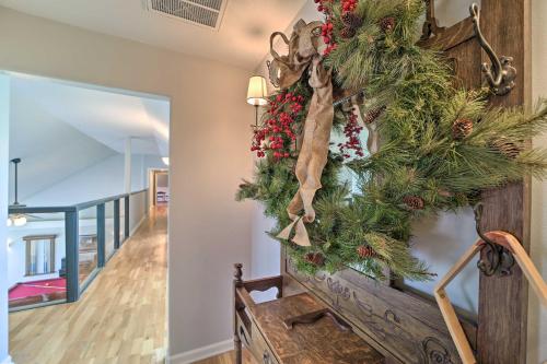 a christmas wreath on the stairs of a house at Grand Tulsa Getaway with Private Pond, Dock and Deck in Tulsa