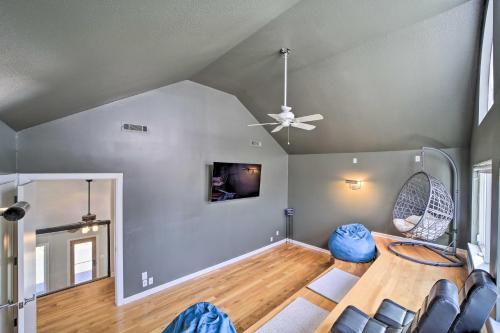 a living room with a ceiling fan and a table at Grand Tulsa Getaway with Private Pond, Dock and Deck in Tulsa