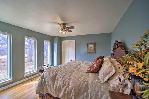a bedroom with a bed and a ceiling fan at Grand Tulsa Getaway with Private Pond, Dock and Deck in Tulsa