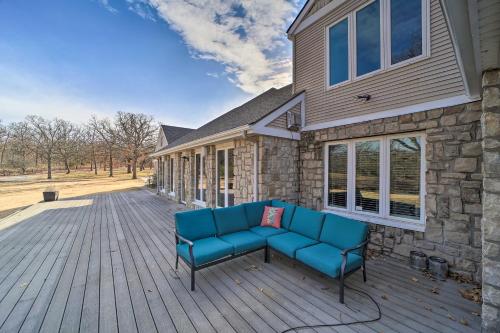 a patio with a couch on a wooden deck at Grand Tulsa Getaway with Private Pond, Dock and Deck in Tulsa