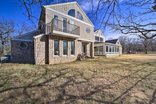 a large white house with a large yard at Grand Tulsa Getaway with Private Pond, Dock and Deck in Tulsa