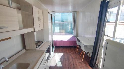 a small kitchen with a sink and a window at Marco Zero Containers 3 in Balneário Camboriú