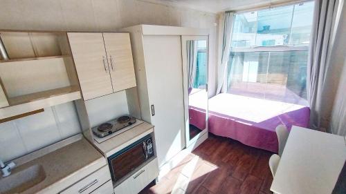 a small room with a bed and a window at Marco Zero Containers 3 in Balneário Camboriú