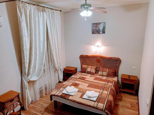 a bedroom with a bed with two pillows on it at Апартаменты в двух шагах от метро in Kharkiv