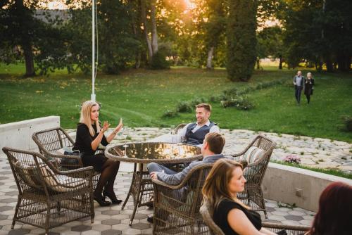 a group of people sitting around a table at Kernu Manor Hotel & SPA in Kernu