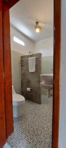 a bathroom with a toilet and a sink at Hotel Xa´an Bacalar in Bacalar