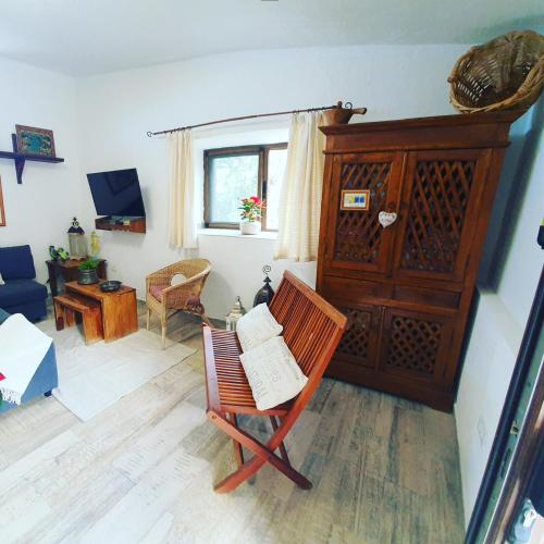 a living room with a chair with a book on it at Casa el Porte in Tegueste